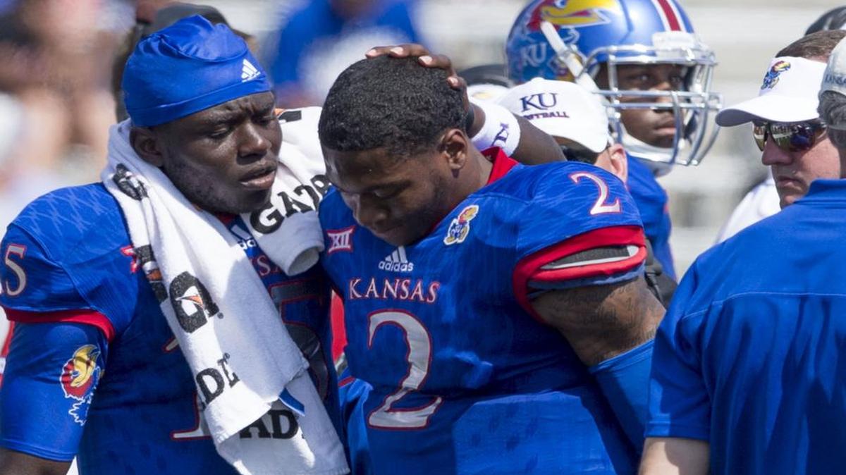 
Kansas wide receiver Bobby Hartzog Jr. checked on quarterback Montell Cozart after Mozart was hit hard on a play in the second quarter Saturday.
