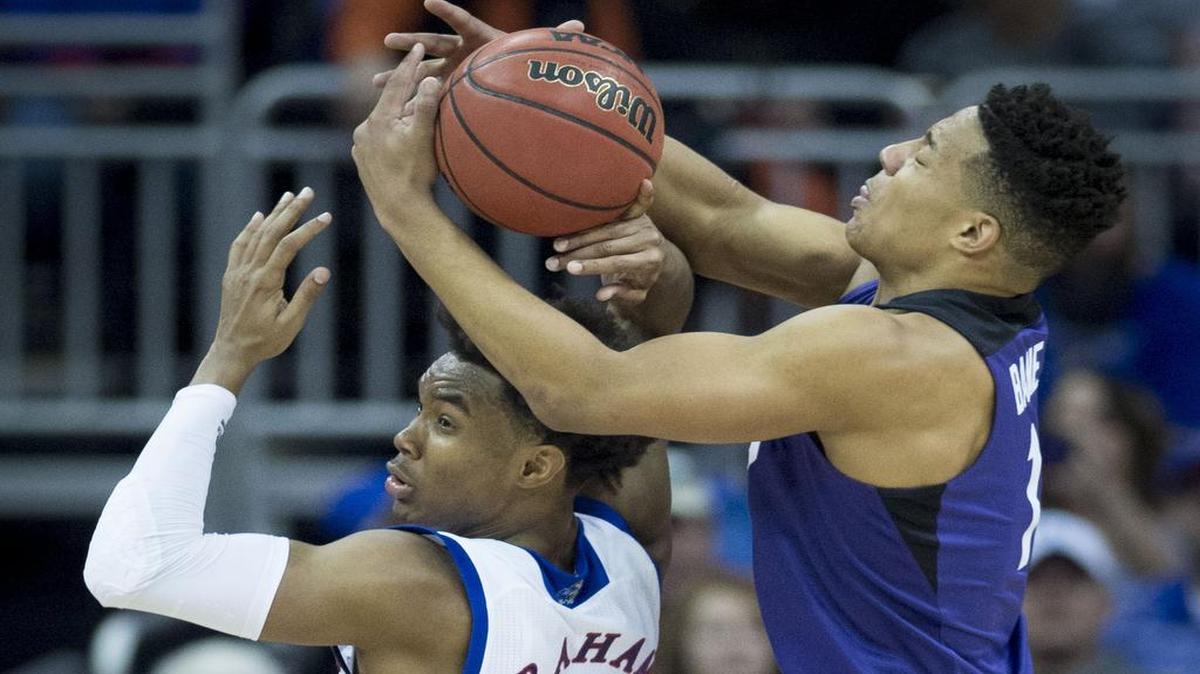 Kansas guard Devonte' Graham (left) said, “I have no idea about any of that,” when asked if he felt the Jayhawks would receive a No. 1 seed in the NCAA Tournament even though they lost to TCU 85-82 in the Big 12 Tournament.