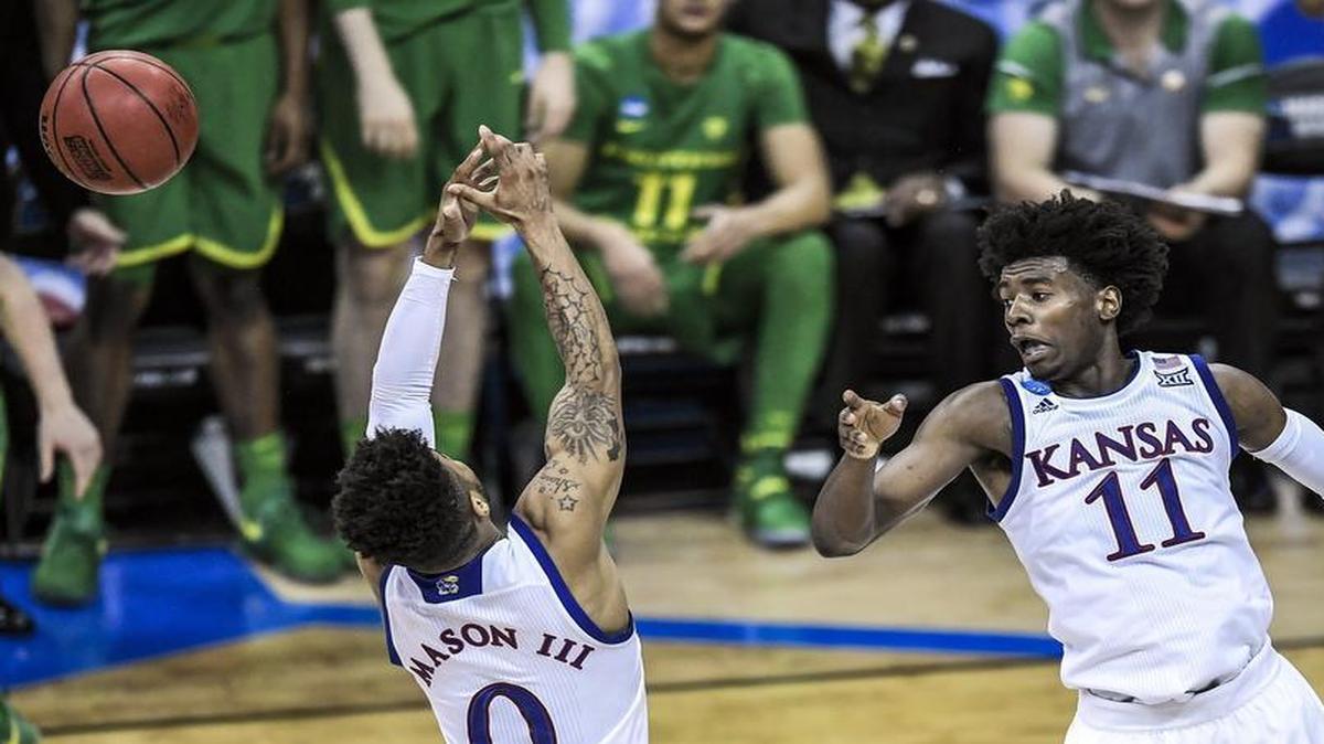 Kansas’ Frank Mason (left) and Josh Jackson couldn’t hang on to a key rebound late in Saturday’s NCAA Tournament Midwest Regional final against Oregon on Saturday at the Sprint Center. The Ducks ended up with the ball and a 74-60 victory.