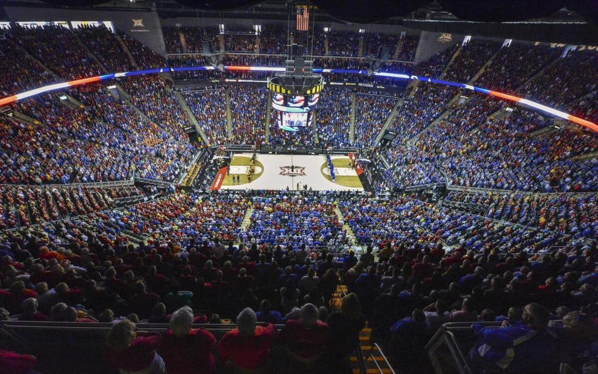 Fans stand as the national anthem is performed before the 2015 Big 12 men’s basketball championship game between the Kansas Jayhawks and Iowa State Cyclones at the Sprint Center.