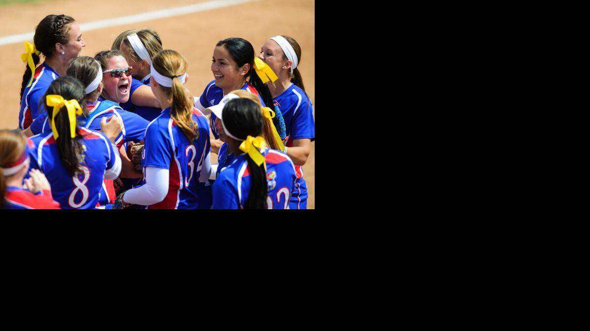 
Kansas players celebrate a 3-1 win over Nebraska in an NCAA college softball regional game Friday in Columbia, Mo.
