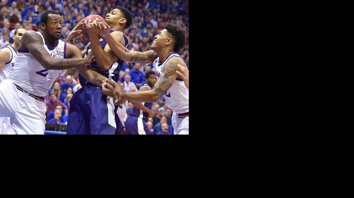 
Kansas freshmen Cliff Alexander (left) and Kelly Oubre surrounded a TCU player on Saturday during KU’s 81-72 victory in Lawrence.

