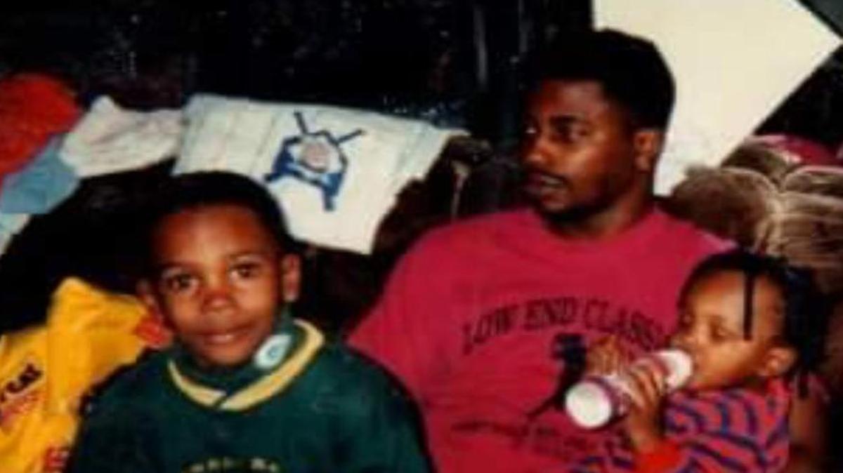 Jamari Traylor, left, shown at approximately 6 years old with his father, Jessie, and his brother, Jamani.