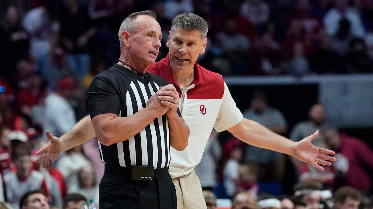 Oklahoma head coach Porter Moser talks to an official in the second half of a game against Arkansas, Saturday, Dec. 11, 2021, in Tulsa, Okla.