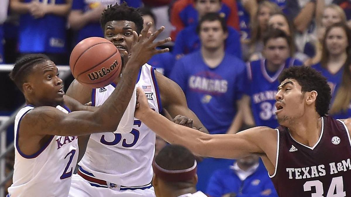 KU's Lagerald Vick (left) and teammate Udoke Azubuike battled Texas A&M’s Tyler Davis for a rebound in the first half of Saturday’s game at Allen Fieldhouse. KU beat A&M, 79-68.