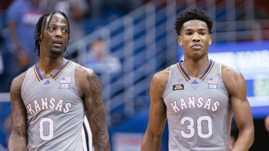 Kansas guard Ochai Agbaji, right, smiles next to teammate Marcus Garrett during a win over UTEP in March of 2021.