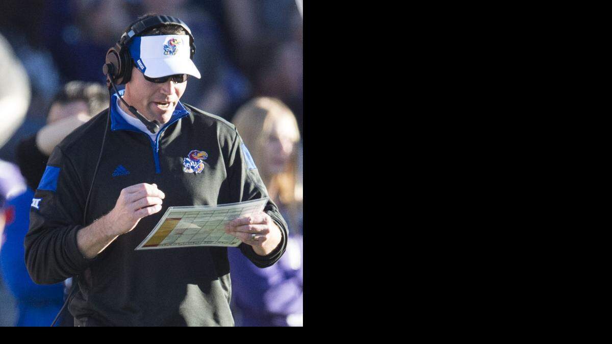 
Kansas Jayhawks head coach Clint Bowen checks his sheet while talking on his headset in the first quarter during the Kansas State University of University of Kansas Sunflower Showdown Big 12 football game at Bill Snyder Family Stadium on Saturday, November 29, 2014, in Manhattan, Kansas.
