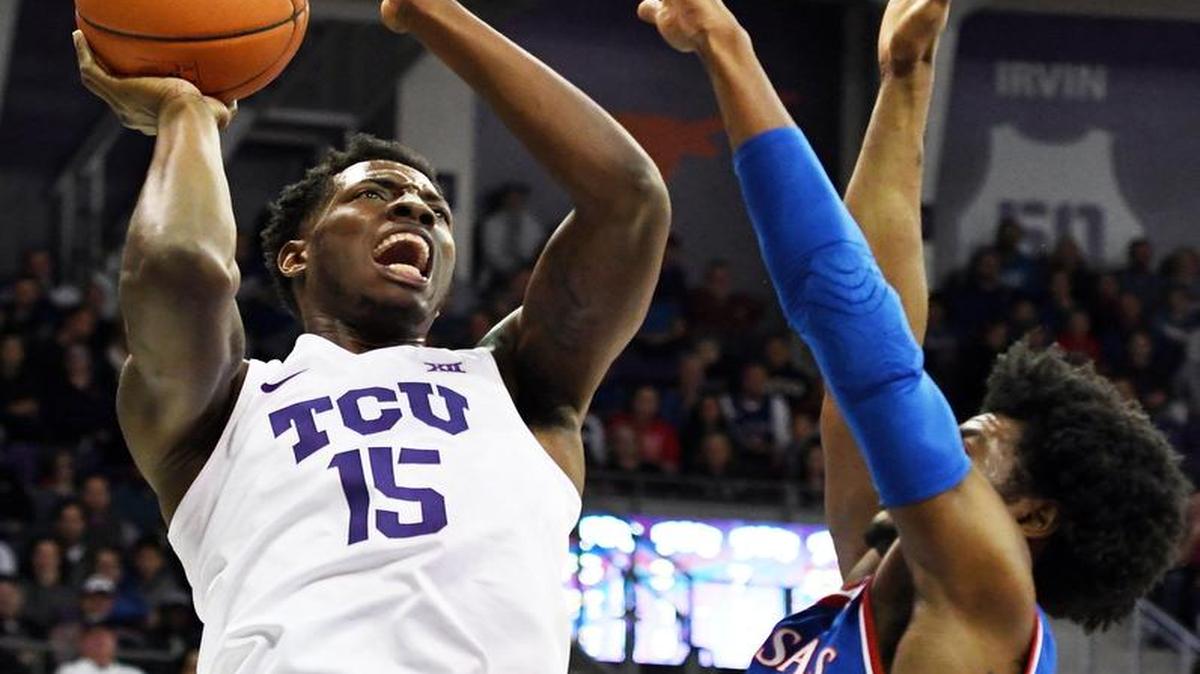 TCU’s J.D. Miller went up for a shot over Kansas’ Josh Jackson during the first half Friday in Fort Worth, Texas. Jackson scored only four points in the Jayhawks’ 86-80 victory.