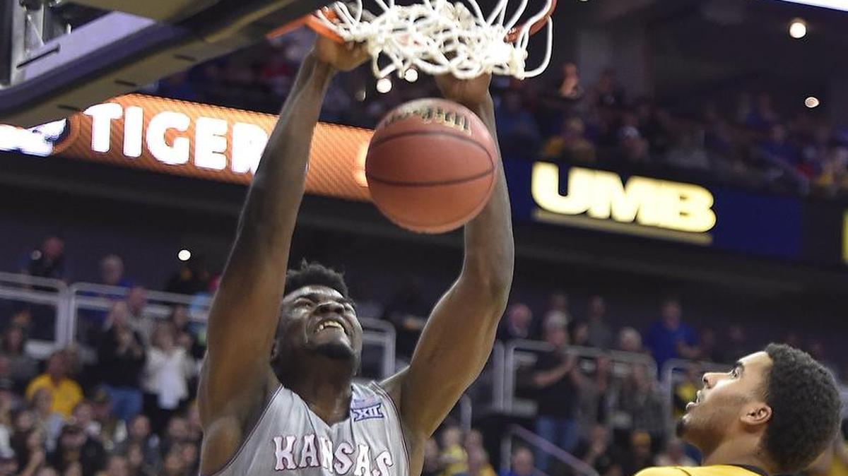 KU’s Udoke Azubuike made all five of his second-half two-point attempts Sunday, including this dunk over Mizzou’s Kevin Puryear (left) and Jontay Porter. KU beat MU 93-87.
