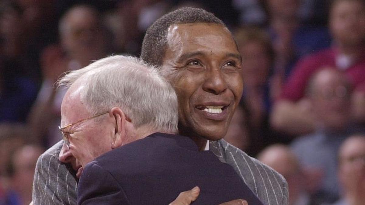 Former KU star Jo Jo White hugged his former coach, Ted Owens, during a 2003 ceremony in which White’s jersey was retired.