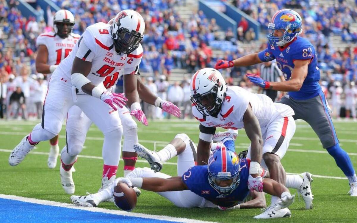 
Kansas wide receiver Darious Crawley put the ball across the goal line for a touchdown as he was defended by Texas Tech defensive back J.J. Gaines (3) and defensive lineman Branden Jackson (9) in the second half Saturday at Memorial Stadium in Lawrence. The Red Raiders beat the Jayhawks 30-20 to keep Kansas winless this season.
