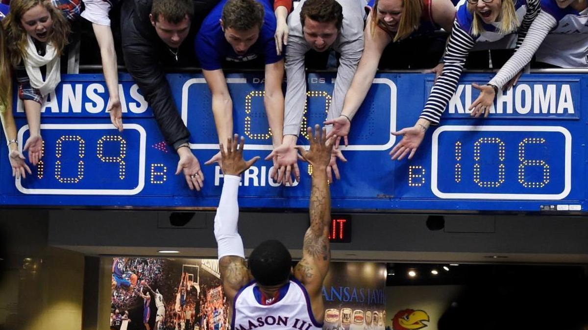 KU's Frank Mason jumped into the arms of his classmates after the Jayhawks beat Oklahoma 109-106 in triple overtime Monday night at Allen Fieldhouse.