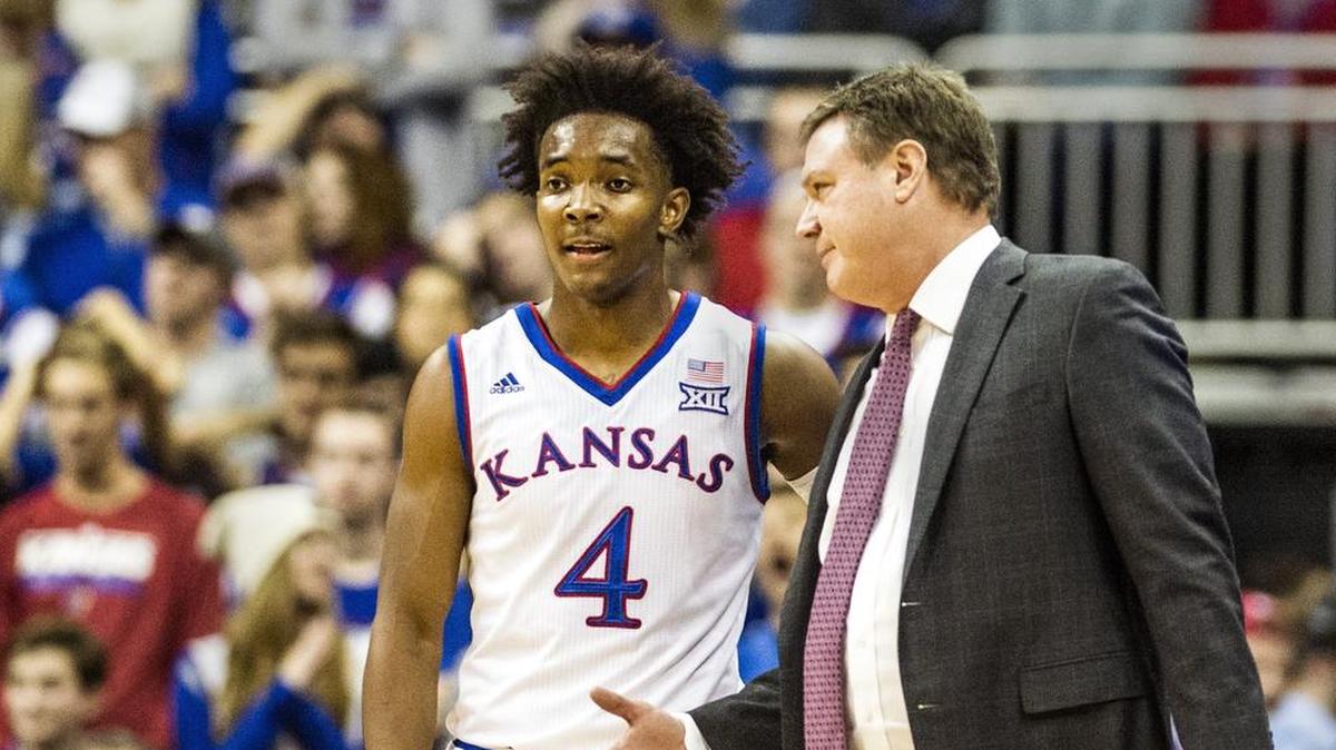 Jayhawks guard Devonte' Graham talked with head coach Bill Self during Wednesday’s loss to Washington at Sprint Center.