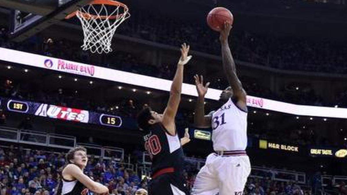 
KU’s Jamari Traylor, who scored 13 points, put up a shot over Utah’s Chris Reyes during the first half of Saturday’s game at the Sprint Center. 

