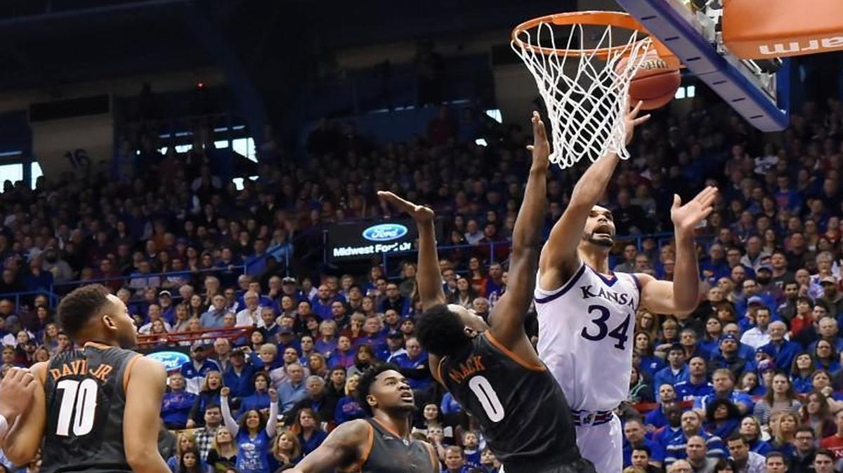 KU’s Perry Ellis, who had a game-high 26 points, powered his way by Texas’ Tevin Mack for a bucket during the second half of Saturday’s game at Allen Fieldhouse. KU beat Texas 76-67.