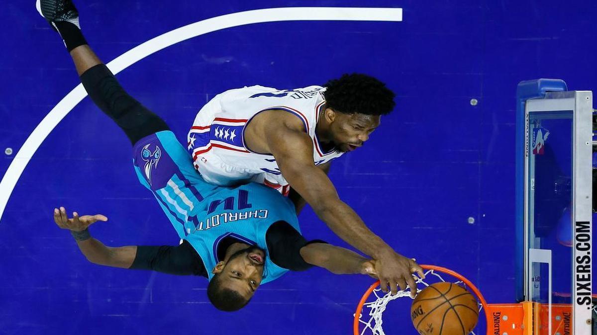 76ers center Joel Embiid, top, dunked over Charlotte’s Michael Kidd-Gilchrist on Jan. 13 in Philadelphia.