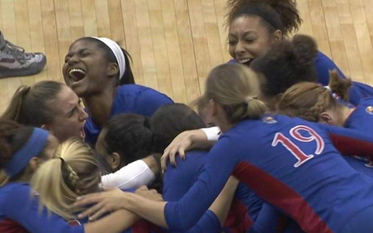 The Kansas volleyball team celebrated after Saturday night’s victory.