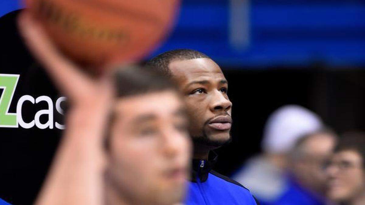 
KU's Cliff Alexander (rear) watched his teammates warm up for Saturday’s game against Texas. Alexander did not suit up for the game after questions about his eligibility came up.
