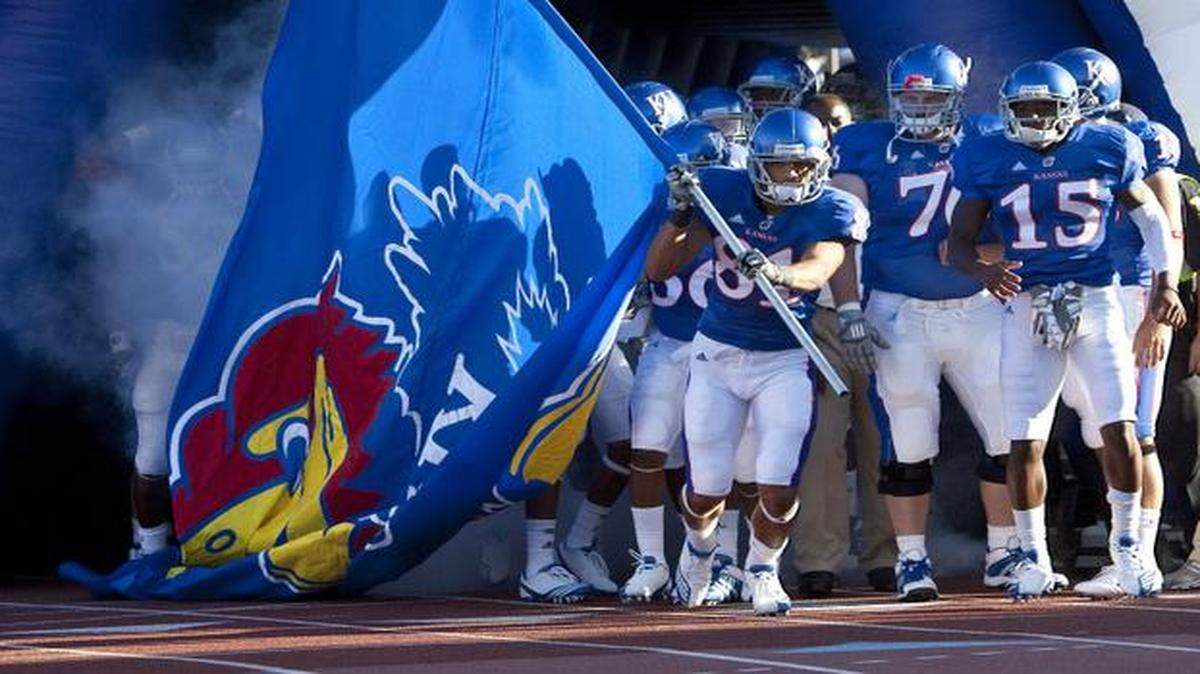 
Kansas football players stand on the track that rings Memorial Stadium before entering the field before a game.
