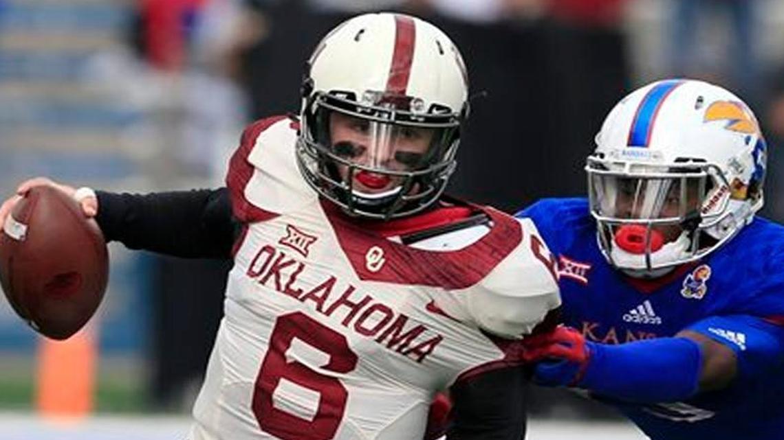Oklahoma quarterback Baker Mayfield got away from Kansas cornerback Chevy Graham in the first half of Saturday’s game in Lawrence.