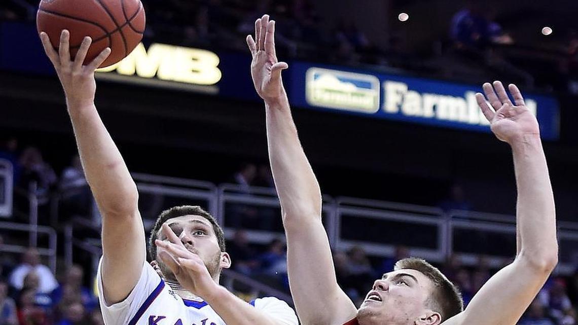 KU’s Svi Mykhailiuk, who started Saturday and scored 13 points, got by Davidson’s Peyton Aldridge on his way to the basket at the Sprint Center. KU beat Davidson 89-71.