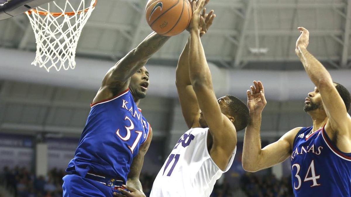 Kansas players Jamari Traylor (31) and Perry Ellis (34) defend the basket from TCU guard Brandon Parrish (11) during the second half of an NCAA college basketball game, Saturday, Feb. 6, 2016, in Fort Worth, Texas. Kansas won 75-56.