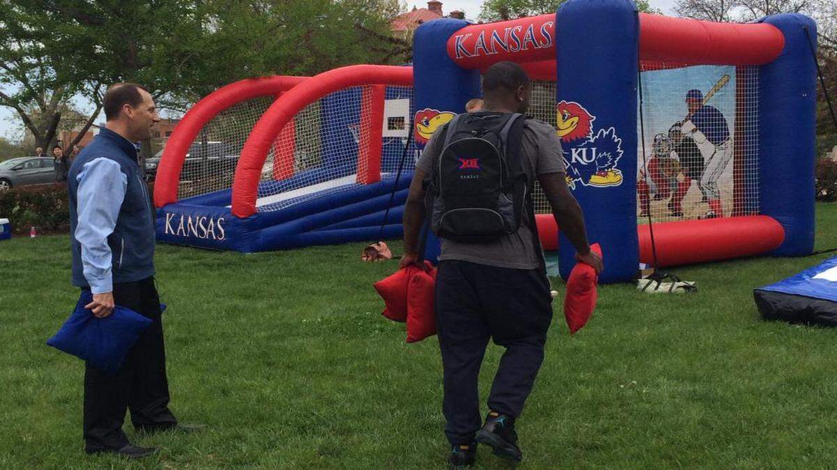 
KU football coach David Beaty (left) played a game of “bags” on Thursday.
