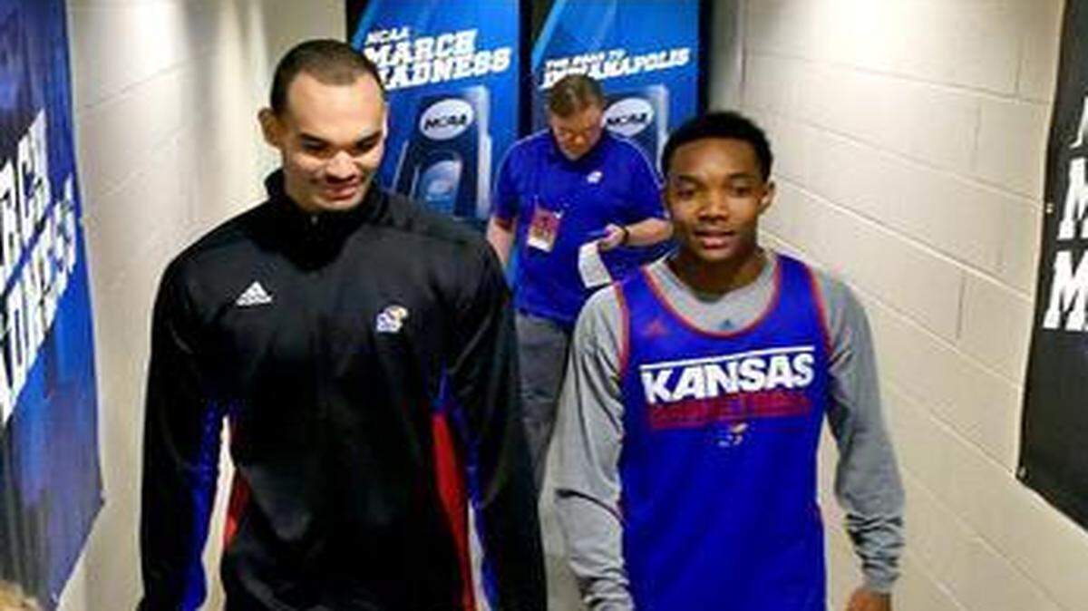 
KU freshman guard Devonte’ Graham (right) and veteran forward Perry Ellis exited the locker room and headed to a news conference Saturday afternoon.

