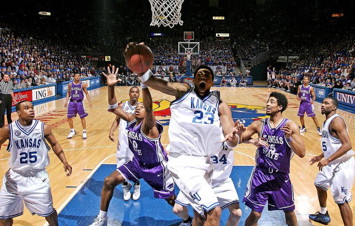 On March 2, 2005, Kansas and K-State battled it out at Allen Fieldhouse where the Jayhawks defeated the Wildcats 72-65. Kansas’ Wayne Simien was surrounded by fellow seniors Michael Lee, left, Aaron Miles, rear, and Keith Langford, right, when he grabbed one of his 20 rebounds in the game.