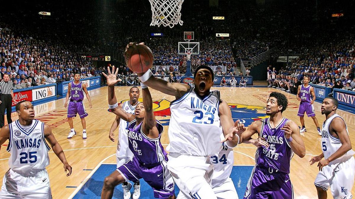 On March 2, 2005, Kansas and K-State battled it out at Allen Fieldhouse where the Jayhawks defeated the Wildcats 72-65. Kansas’ Wayne Simien was surrounded by fellow seniors Michael Lee, left, Aaron Miles, rear, and Keith Langford, right, when he grabbed one of his 20 rebounds in the game.