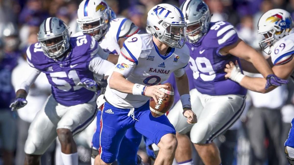 Kansas State defensive end Reggie Walker (51) looks to make a sack against the Kansas Jayhawks.