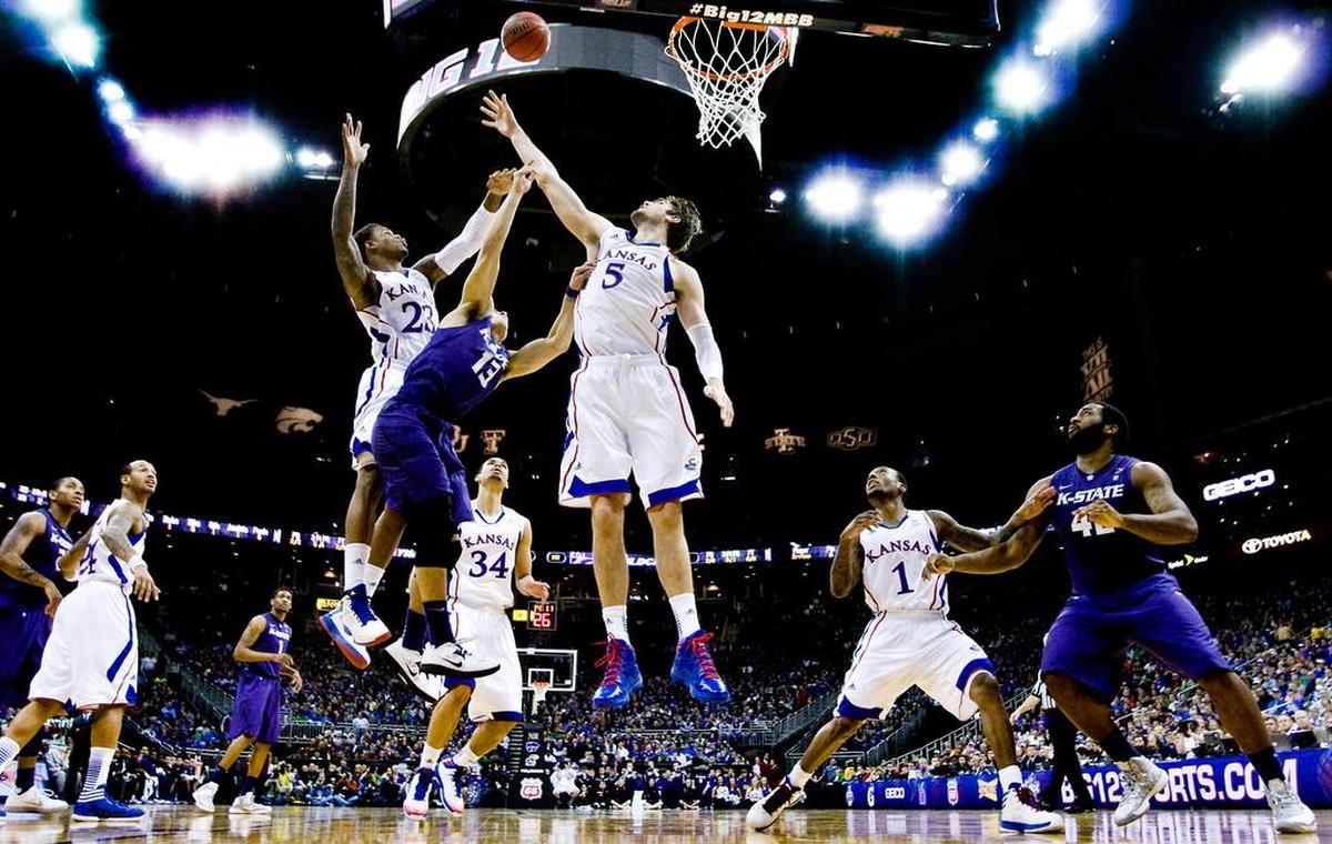 K-State’s Angel Rodriguez (13) found himself in a tough spot when he decided to drive inside on KU’s bigs during the first half of the Big 12 Tournament title game at the Sprint Center.