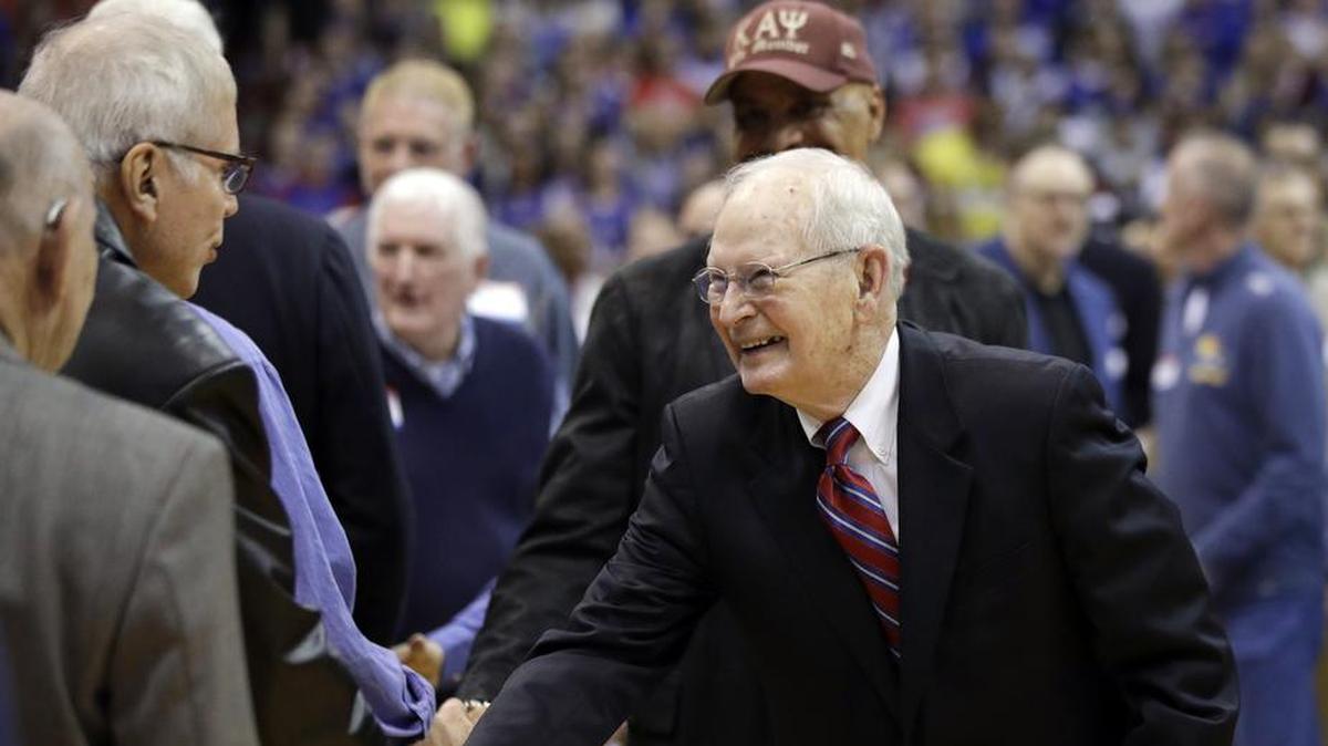 In this file photo, Former Kansas coach Ted Owens greeted former players and coaches during a halftime celebration of 120 years of Kansas basketball at Allen Fieldhouse.
