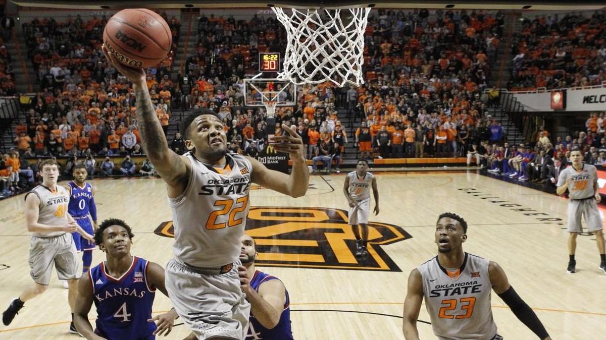 Oklahoma State guard Jeff Newberry took a shot in front of Kansas guard Devonte’ Graham (left), forward Perry Ellis and Cowboys teammate guard Leyton Hammonds during a game last month in Stillwater, Okla. Oklahoma State won 86-67.
