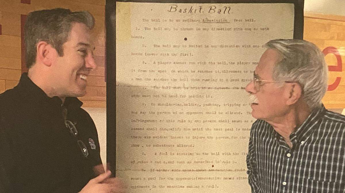 Brian Hanni, left, is pictured with Jim Naismith, the grandson of James Naismith.