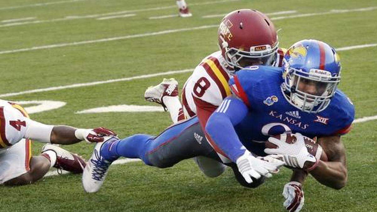 
Kansas wide receiver Nigel King dived forward after being tackled by Iowa State defensive back Kenneth Lynn during Saturday night’s game.
