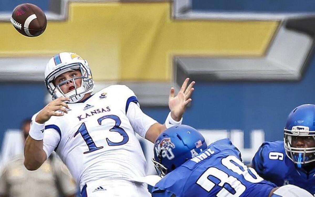 Memphis defender Shareef White (right) knocked the ball away from Kansas quarterback Ryan Willis during the Tigers’ victory on Sept. 17.