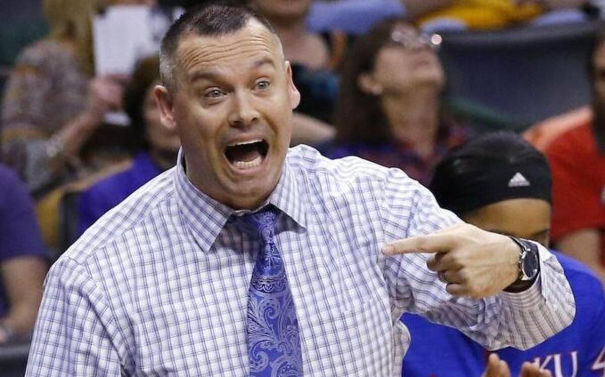 Kansas coach Brandon Schneider talked to his players during the first half against Texas.