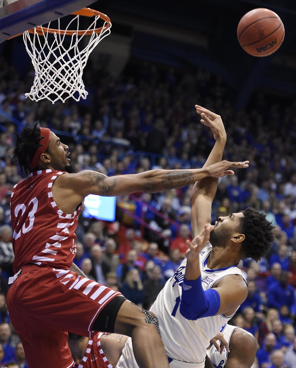KU’s Dedric Lawson,  struggles to get a shot off over Louisiana’s JaKeenan Gant during the first half of Friday’s game at Allen Fieldhouse.