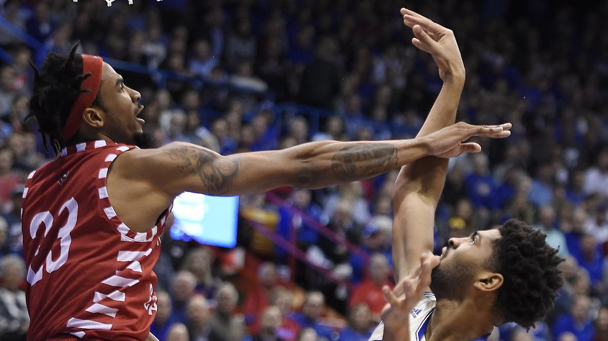 KU’s Dedric Lawson,  struggles to get a shot off over Louisiana’s JaKeenan Gant during the first half of Friday’s game at Allen Fieldhouse.