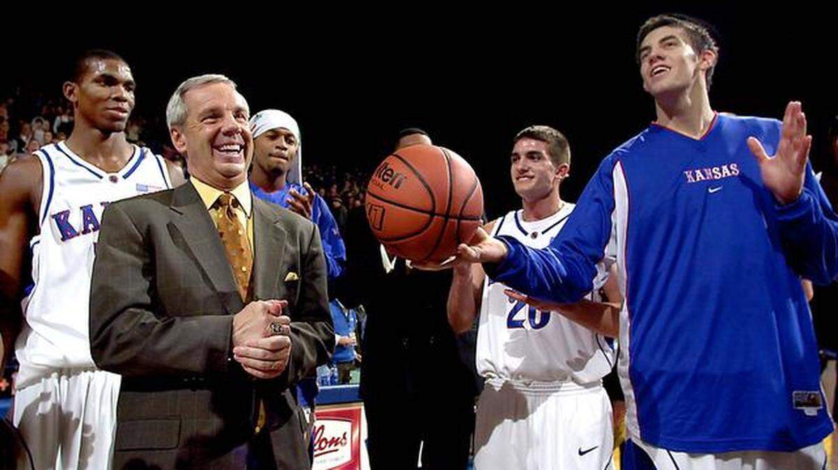 
Roy Williams got the game ball after posting his 400th win in 2003 at Allen Fieldhouse. Senior Nick Collison (right) presented him the game ball. At left is Bryant Nash.