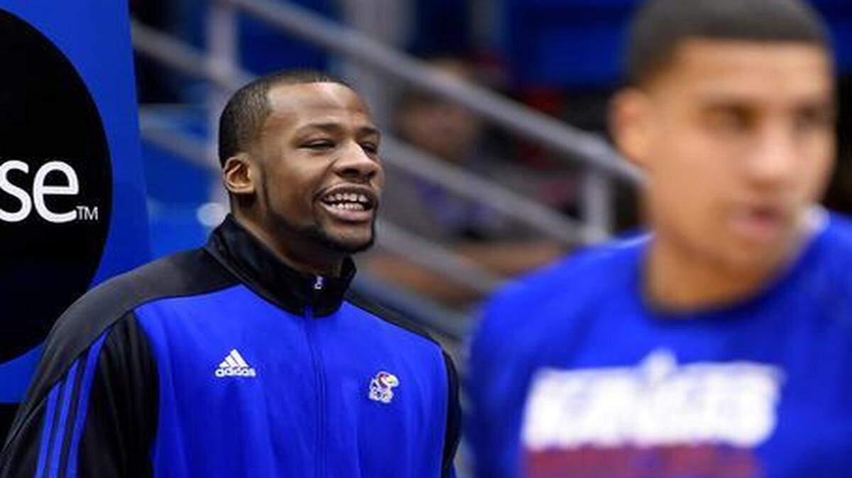 
KU's Cliff Alexander (left) watched his teammates warm up for Saturday’s game against Texas. Alexander did not suit up for the game after questions about his eligibility came up.
