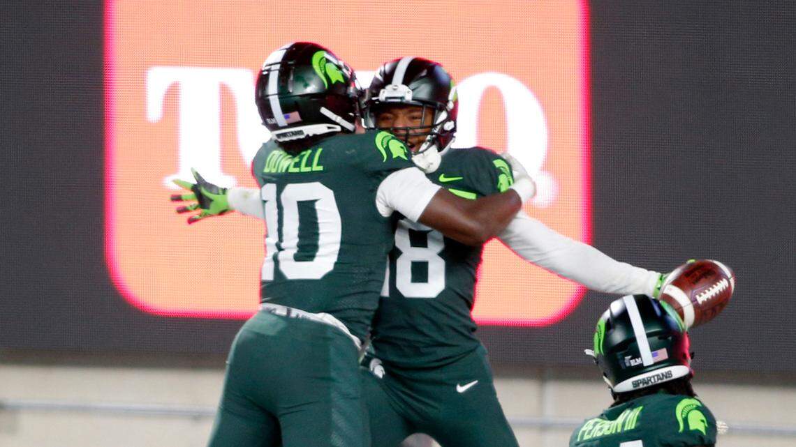 Michigan State’s Michael Dowell, left, Kalon Gervin, center, and Tre Person, right, celebrate Gervin’s fumble recovery for a touchdown at the conclusion of a game against Northwestern, Saturday, Nov. 28, 2020, in East Lansing, Mich.