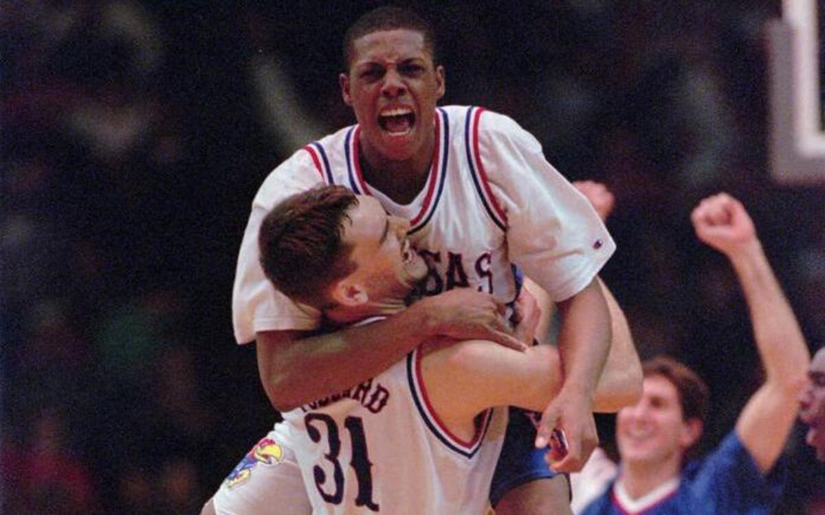Kansas forward Paul Pierce (34) leaps into the arms of teammate Scot Pollard (31) after Kansas defeated Arizona Wildcats 83-80 in the NCAA West Regional semifinal game in Denver on Friday, March 22, 1996.