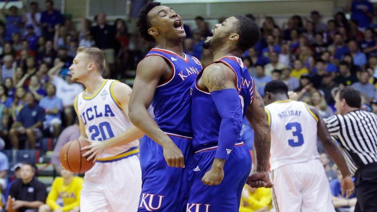 Kansa’ Frank Mason (center right) celebrated with teammate Devonte’ Graham (center, left) after scoring, as UCLA’s Bryce Alford (20) and Aaron Holiday (3) walked away in the first half of their Maui Invitational semifinal game Tuesday in Lahaina, Hawaii.