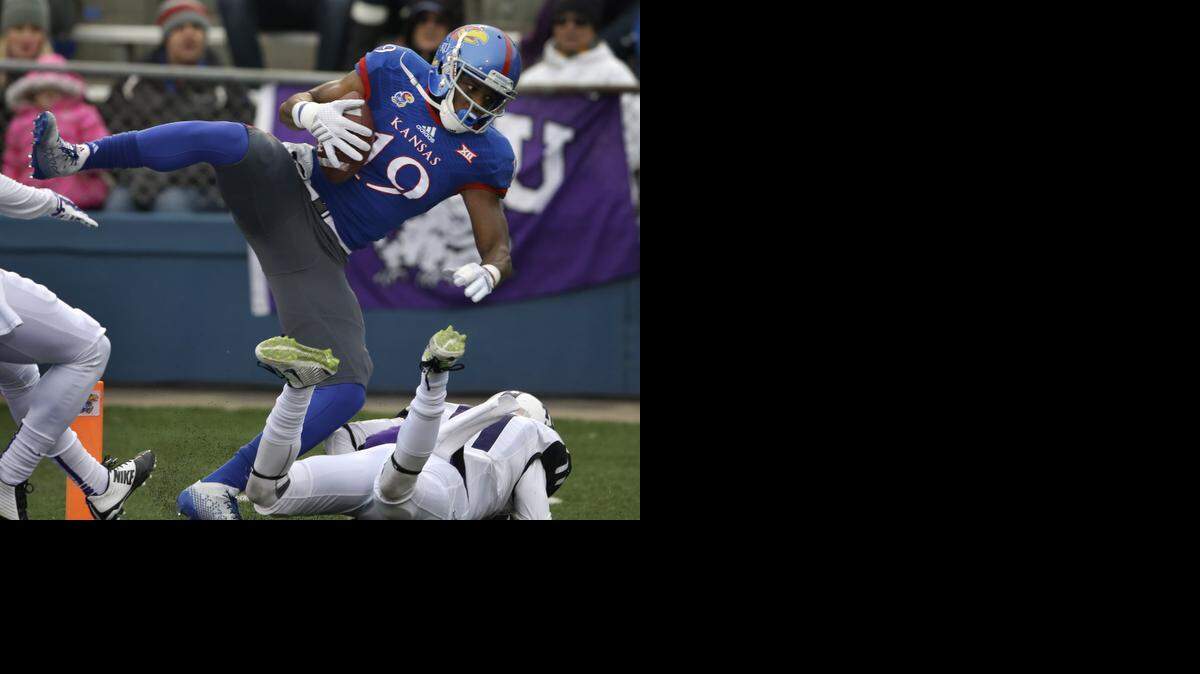 Kansas wide receiver Justin McCay (19) lands out of bounds while covered by TCU cornerback Ranthony Texada (11) during the first half of an NCAA college football game in Lawrence, Kan., Saturday, Nov. 15, 2014.