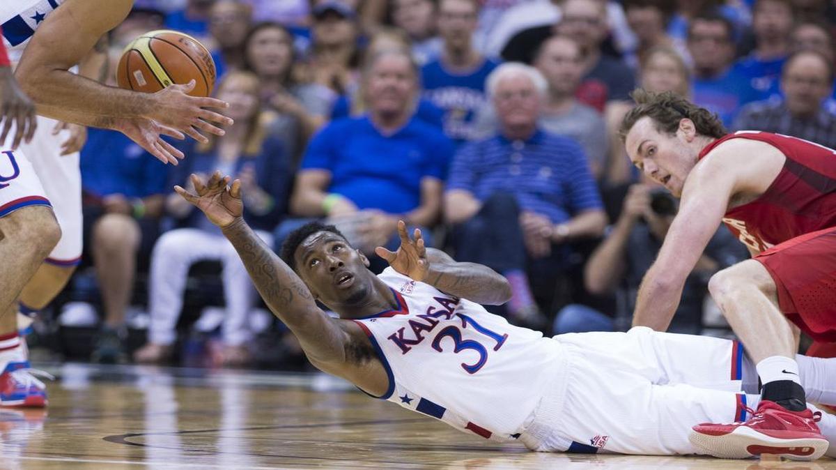 
Kansas forward Jamari Traylor (31) passed the ball to teammate Perry Ellis as Team Canada forward Chris McLaughlin (12) defended Friday’s exhibition basketball game at the Sprint Center.

