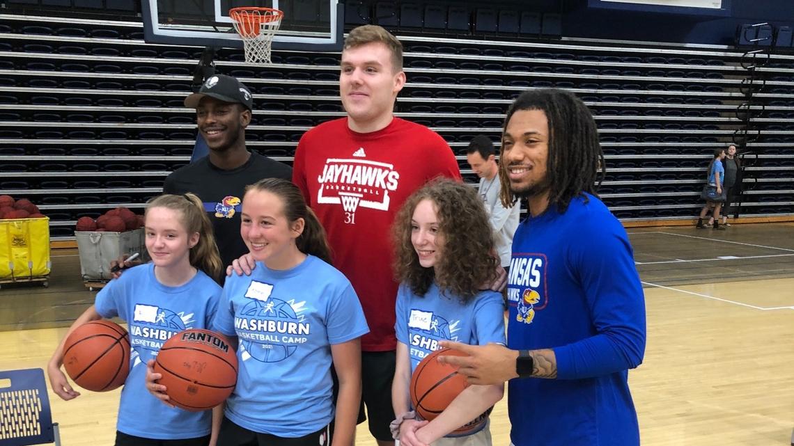 Kansas basketball players Jalen Coleman-Lands, Cam Martin and Bobby Pettiford pose for a photo with campers at Washburn coach Brett Ballard’s basketball camp on July 1, 2021.