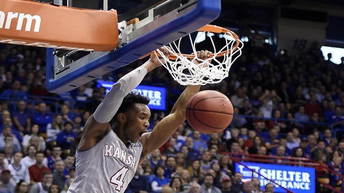 Kansas’ guard Devonte’ Graham got in a dunk in the game against Harvard on Dec. 5 at Allen Fieldhouse.