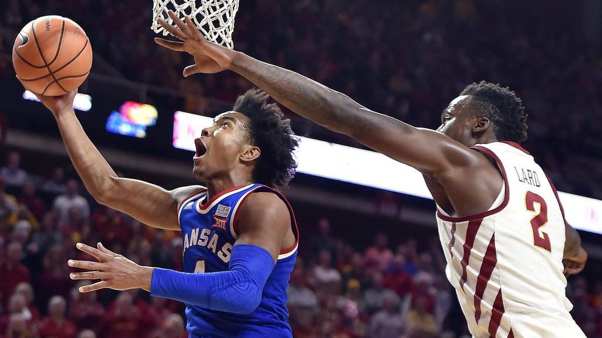KU’s Devonté Graham sailed past Iowa State’s Cameron Lard on his way to the basket in the second half of Tuesday night’s game in Ames, Iowa. The Jayhawks beat the Cyclones 83-77.